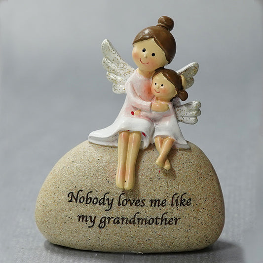 Angel grandmother with granddaughter on stone