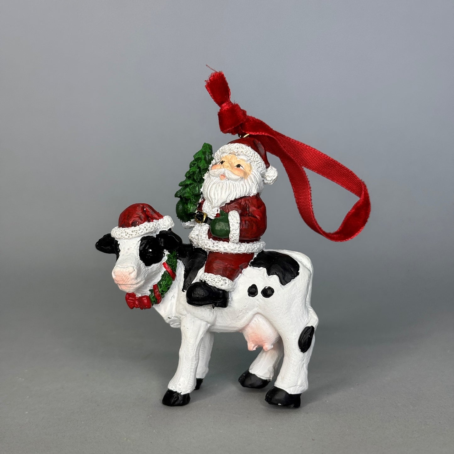 Santa on cow tree trim 6x3.5x8cm